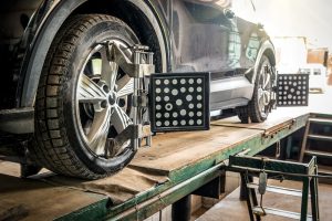 Car wheel alignment Auto camber toe check fixing Sensor during suspension adjustment and automobile wheel alignment work at the repair service station
